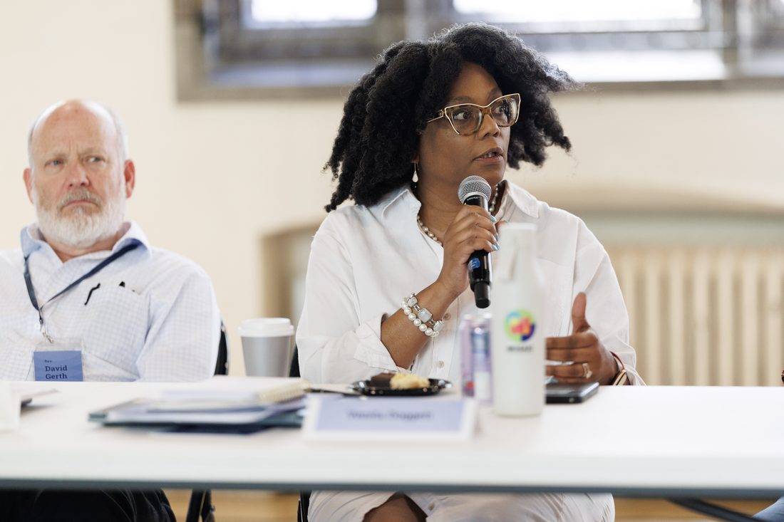 A participant addressing the table with a microphone