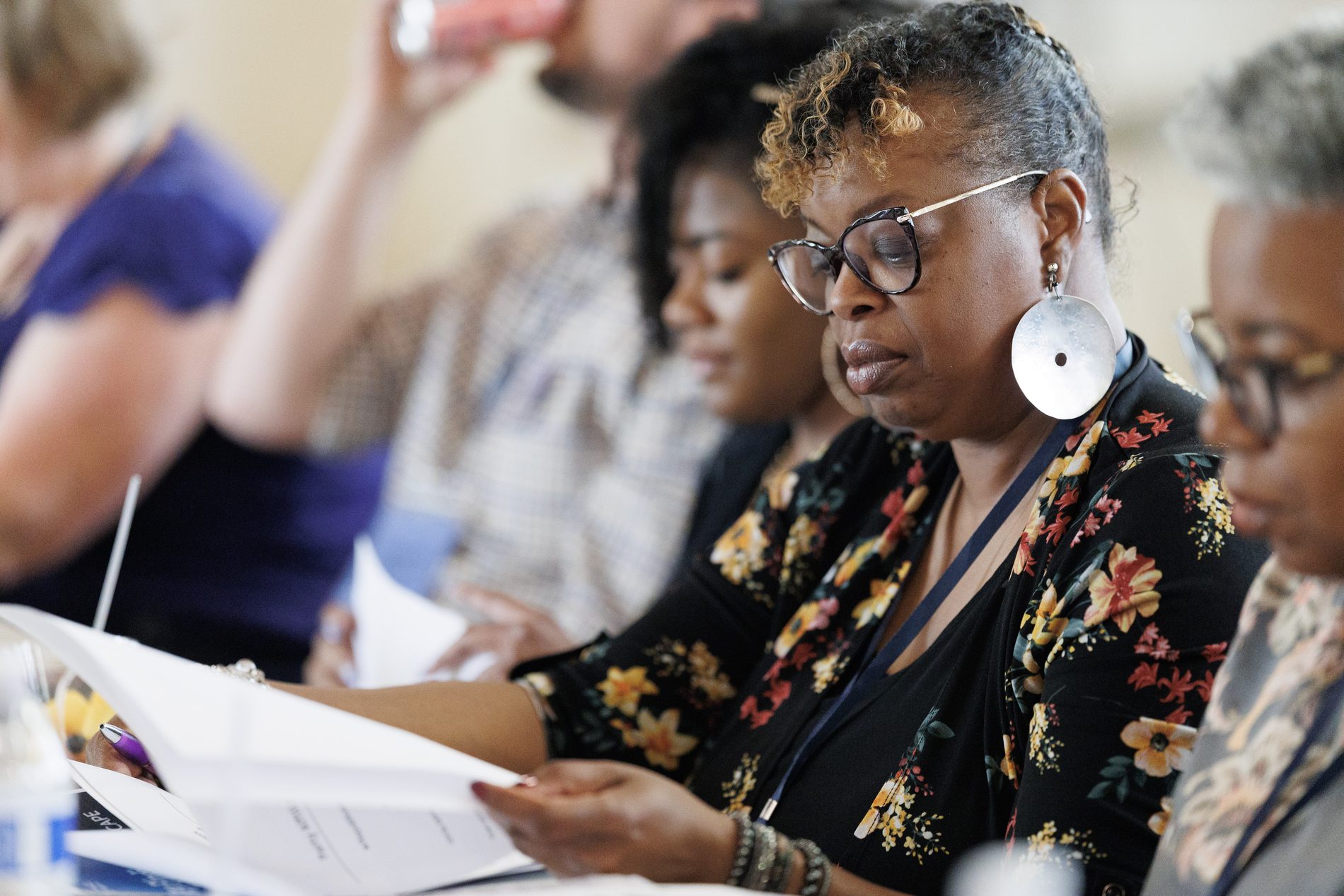 A participant reading materials during the convening